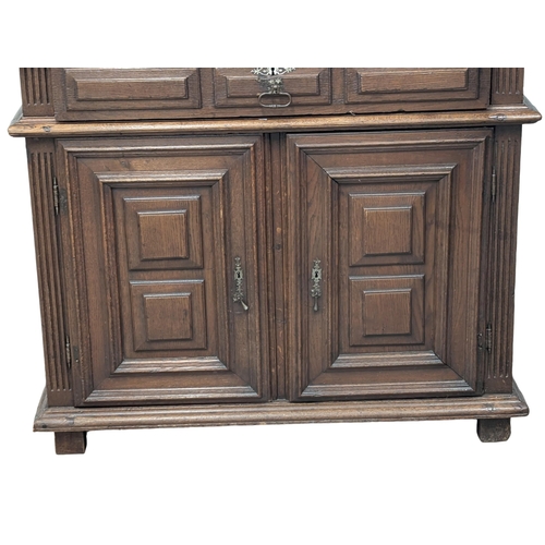 275 - A large late 17th/Early 18th century North European 2 piece oak court cupboard with geometric handle... 