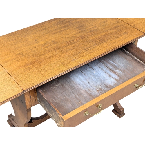 287 - A Late 19th Century North European walnut sofa table on stretcher base. With 1 drawer and dummy draw... 