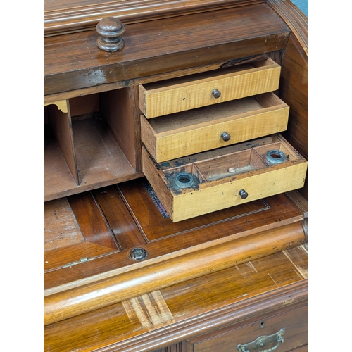 29 - A large 19th century Victorian walnut cylinder top desk. With Birdseye maple interior drawers. 137cm... 