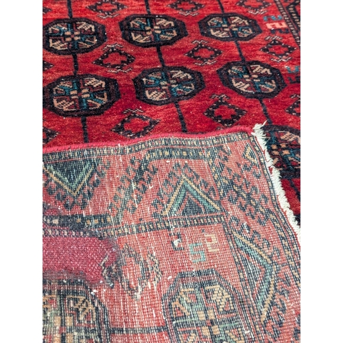 299 - A vintage Middle Eastern hand knitted rug. 103x218cm. 6