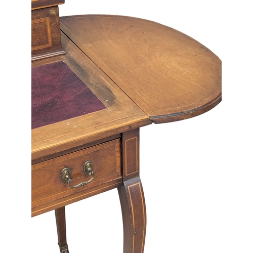 352 - An Edwardian inlaid mahogany dropleaf writing table with leather top and brass gallery. 107x47x86cm ... 