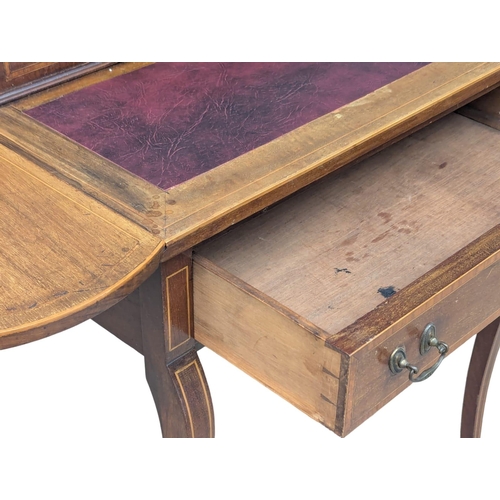 352 - An Edwardian inlaid mahogany dropleaf writing table with leather top and brass gallery. 107x47x86cm ... 