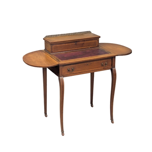 352 - An Edwardian inlaid mahogany dropleaf writing table with leather top and brass gallery. 107x47x86cm ... 