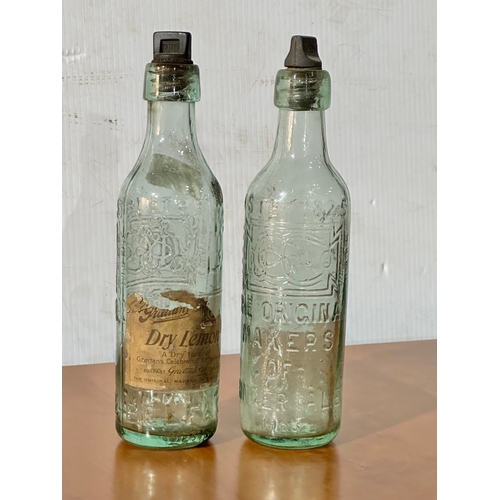 56 - 2 vintage Grattan’s glass bottles. Grattan’s Belfast bottle, the original makers of ginger ale. 25cm
