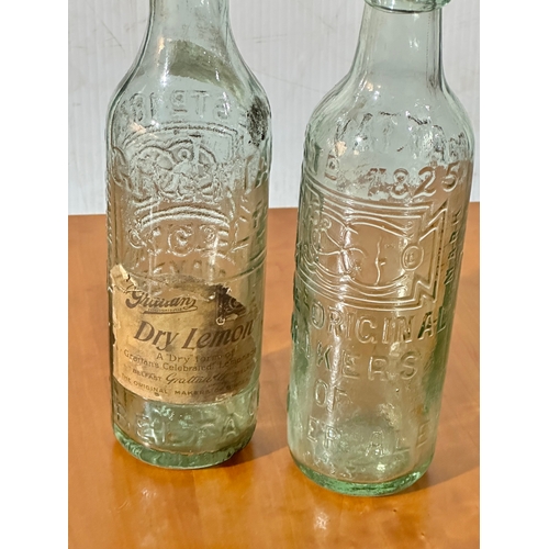 56 - 2 vintage Grattan’s glass bottles. Grattan’s Belfast bottle, the original makers of ginger ale. 25cm