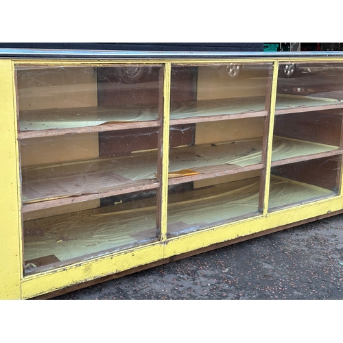 15 - A very large vintage shops counter. With glass front and cupboard doors. 305x61x92cm