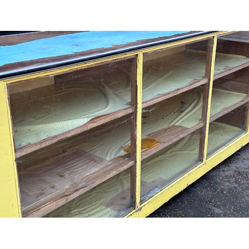 15 - A very large vintage shops counter. With glass front and cupboard doors. 305x61x92cm