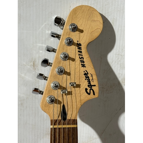 41 - A Squier Mustang guitar. Fender.