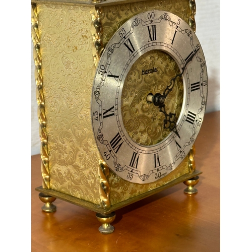 13 - An engraved brass Hermle mantle clock. 13x8x23cm