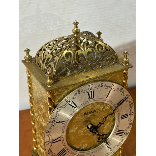 13 - An engraved brass Hermle mantle clock. 13x8x23cm