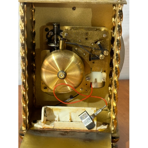 13 - An engraved brass Hermle mantle clock. 13x8x23cm