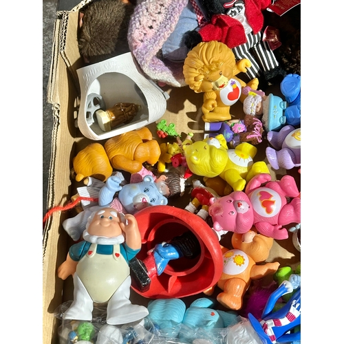 43 - A box of vintage dolls and toys. Care Bears, Smirfs etc