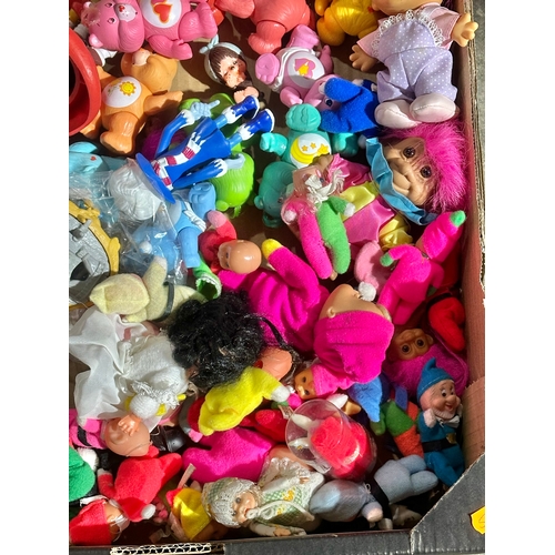 43 - A box of vintage dolls and toys. Care Bears, Smirfs etc