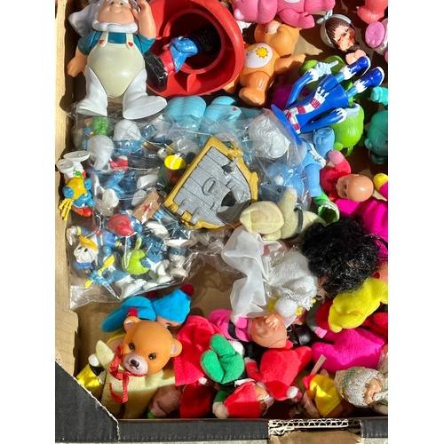 43 - A box of vintage dolls and toys. Care Bears, Smirfs etc