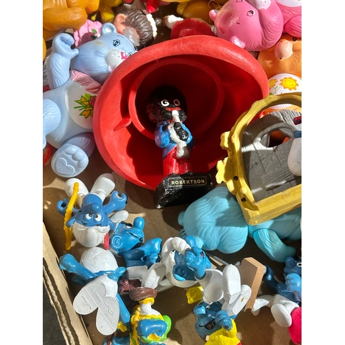 43 - A box of vintage dolls and toys. Care Bears, Smirfs etc