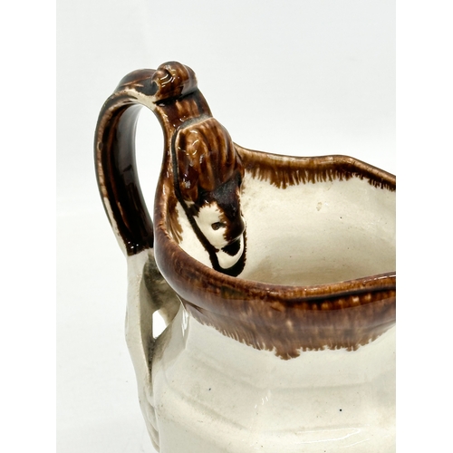 417 - An unusual Mid 19th Century Early Victorian glazed jug. 13x9x16cm