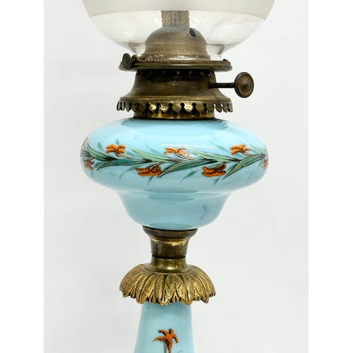 89 - A large 19th Century Bohemian painted opaline glass oil lamp a on gilt brass base. 66cm