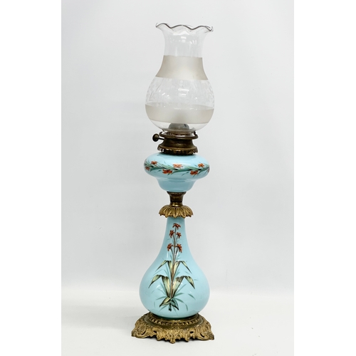 89 - A large 19th Century Bohemian painted opaline glass oil lamp a on gilt brass base. 66cm