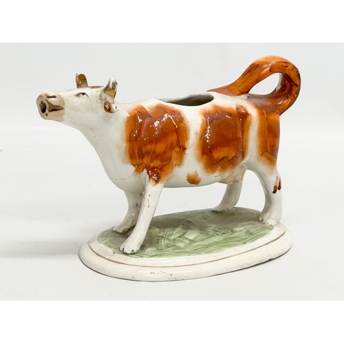 421 - A 19th Century Victorian Staffordshire pottery cow creamer. 17cm