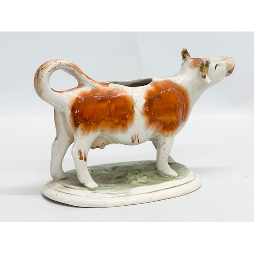 421 - A 19th Century Victorian Staffordshire pottery cow creamer. 17cm