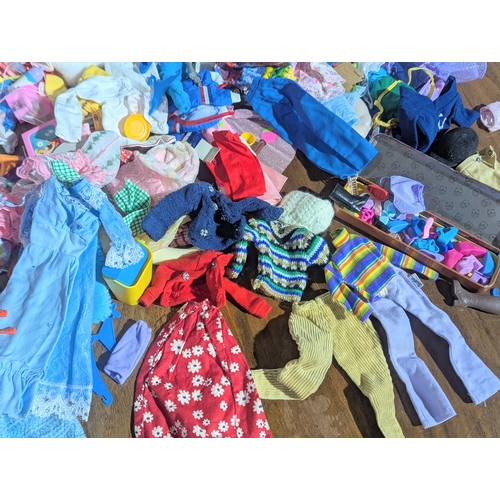 54 - A large collection of vintage doll clothes, accessories, etc. Barbie, Sindy, etc