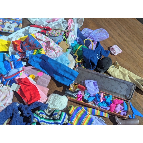54 - A large collection of vintage doll clothes, accessories, etc. Barbie, Sindy, etc