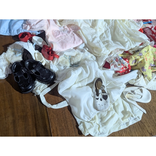55 - A collection of vintage doll clothes, shoes, accessories, etc.