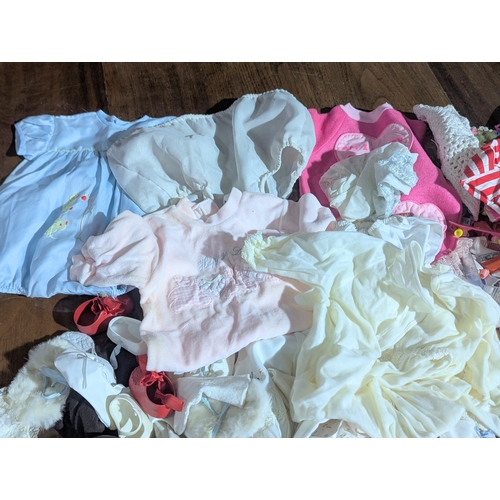 55 - A collection of vintage doll clothes, shoes, accessories, etc.