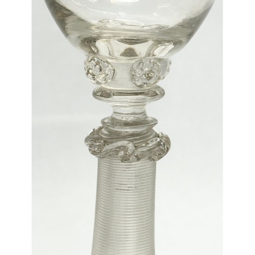 19 - A set of four 18th Century wine glasses with threaded columns and bases. 18.5cm.