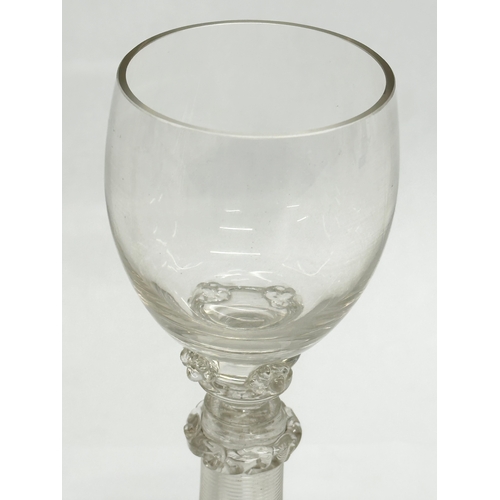 19 - A set of four 18th Century wine glasses with threaded columns and bases. 18.5cm.