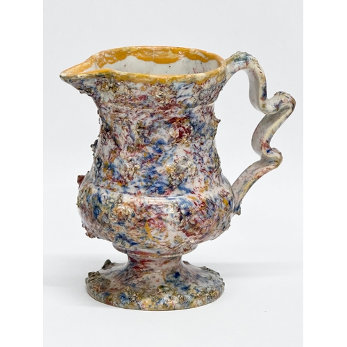 11 - An 18th Century salt glazed agate earthenware creamer. 14x8x13cm