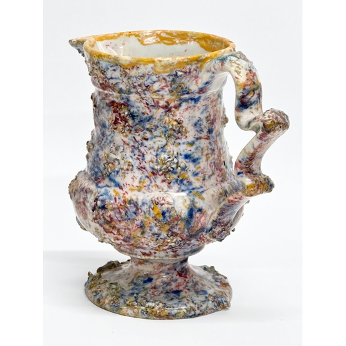 11 - An 18th Century salt glazed agate earthenware creamer. 14x8x13cm