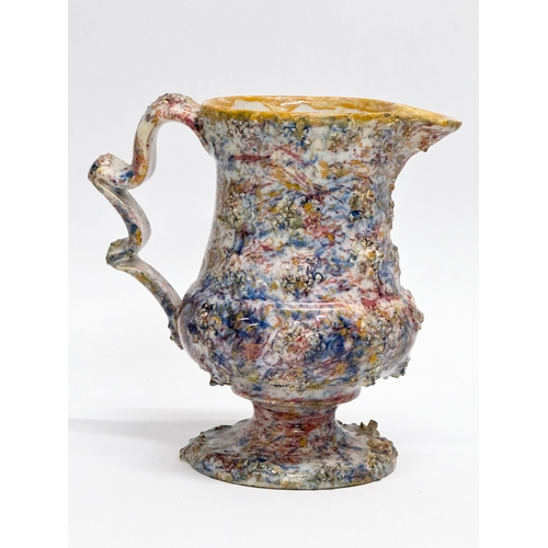 11 - An 18th Century salt glazed agate earthenware creamer. 14x8x13cm