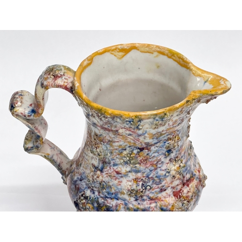 11 - An 18th Century salt glazed agate earthenware creamer. 14x8x13cm