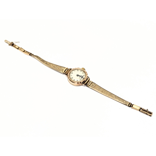 740 - A vintage ladies 9ct gold cased watch with rolled gold straps.