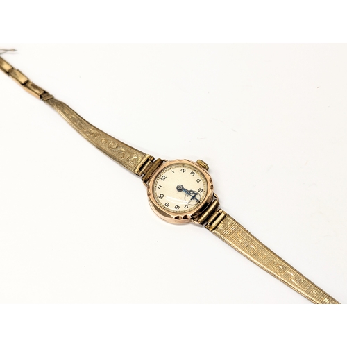 740 - A vintage ladies 9ct gold cased watch with rolled gold straps.