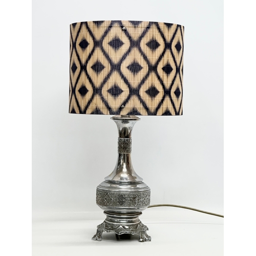 680 - The Silverlight Company Limited. A large embossed plated French table lamp. 56cm with shade. Base 41... 