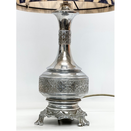 680 - The Silverlight Company Limited. A large embossed plated French table lamp. 56cm with shade. Base 41... 