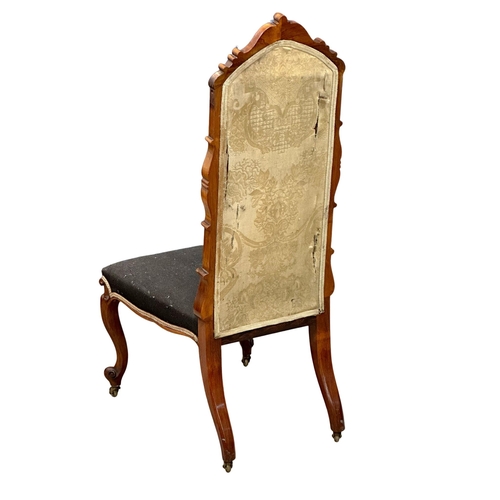 140 - A 19th Century Victorian walnut ladies chair with original needlework upholstery and carved cabriole... 