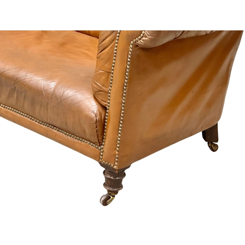 4 - A 19th Century Victorian deep button leather Chesterfield sofa, on turned mahogany legs. Circa 1880.... 