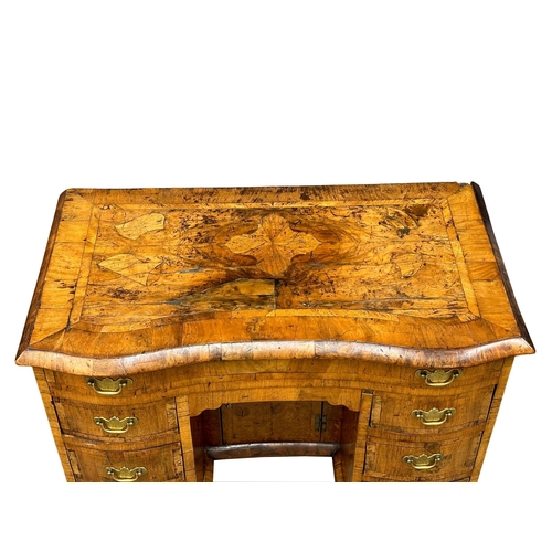 5 - An Early 18th Century, George I figured walnut kneehole desk. George I (1714-1727) with original bra... 