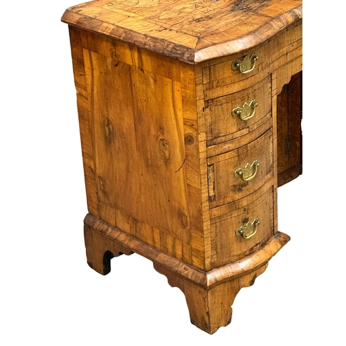 5 - An Early 18th Century, George I figured walnut kneehole desk. George I (1714-1727) with original bra... 