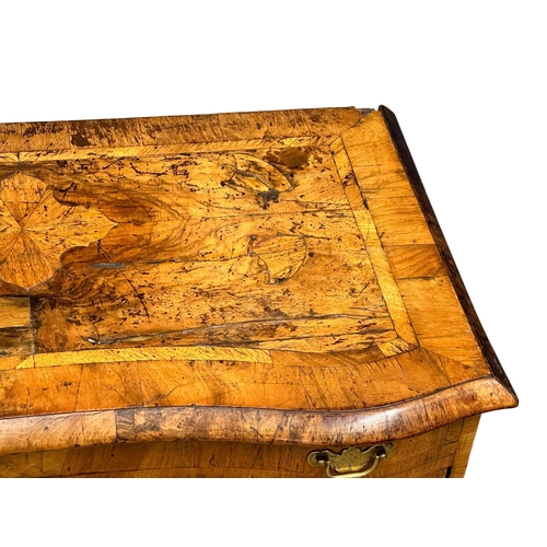 5 - An Early 18th Century, George I figured walnut kneehole desk. George I (1714-1727) with original bra... 