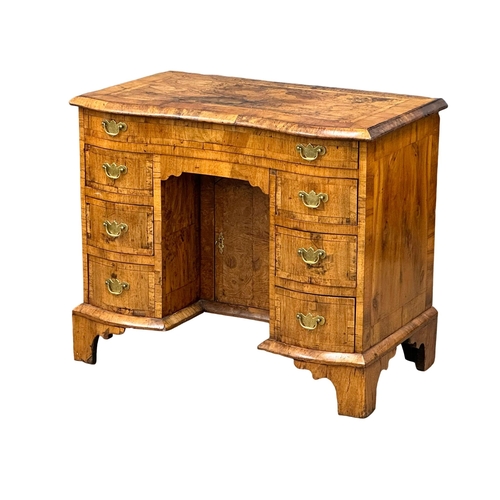 5 - An Early 18th Century, George I figured walnut kneehole desk. George I (1714-1727) with original bra... 