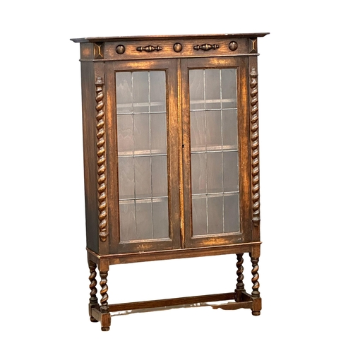 783 - An Early 20th Century oak bookcase with astragal glazed doors and adjustable shelves. In the Jacobea... 