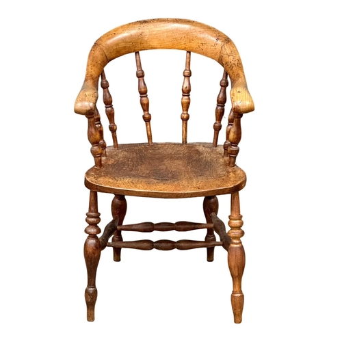 93 - A Mid 19th Century Victorian elm desk chair/armchair with bowed arms and turned supports.