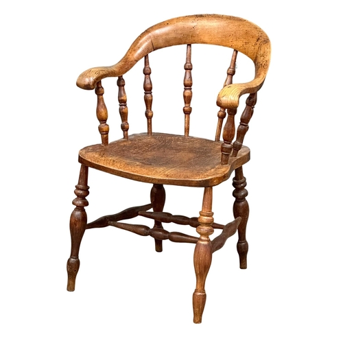 93 - A Mid 19th Century Victorian elm desk chair/armchair with bowed arms and turned supports.