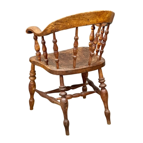 93 - A Mid 19th Century Victorian elm desk chair/armchair with bowed arms and turned supports.