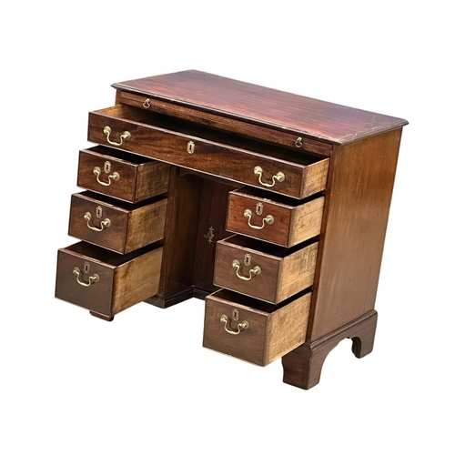 94 - An 18th Century George III mahogany kneehole desk. With original brass handles and brushing slide. C... 