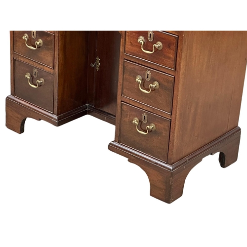 94 - An 18th Century George III mahogany kneehole desk. With original brass handles and brushing slide. C... 